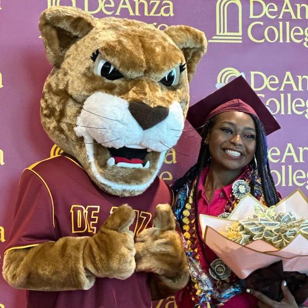 Roary with young woman in grad gear