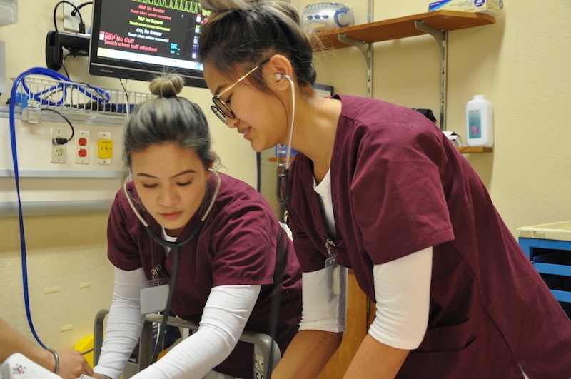 two nursing students at bedside