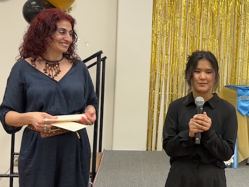 student on stage with counselors