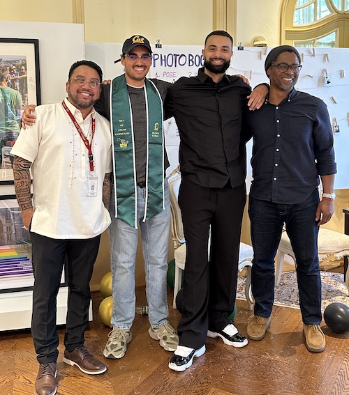 3 counselors and smiling young man with green grad stole