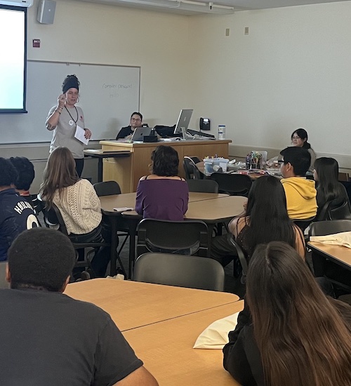 faculty member speaking to students