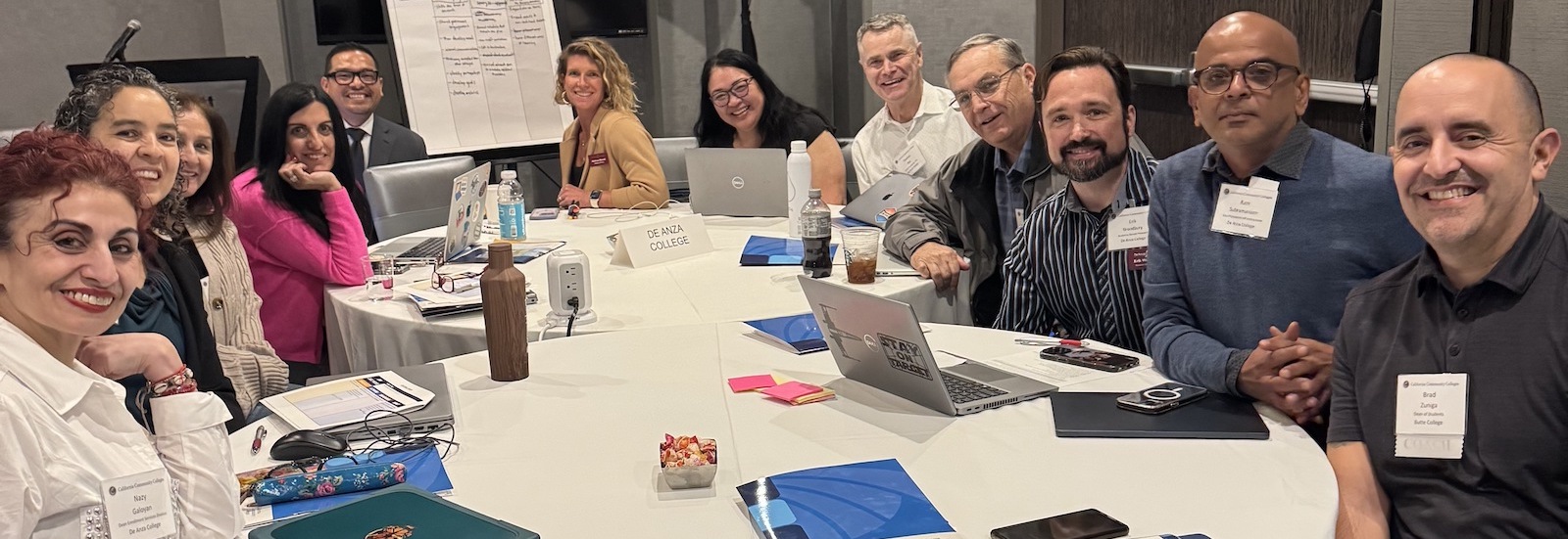 people smiling around a conference table