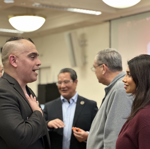 President Torres speaking with faculty member