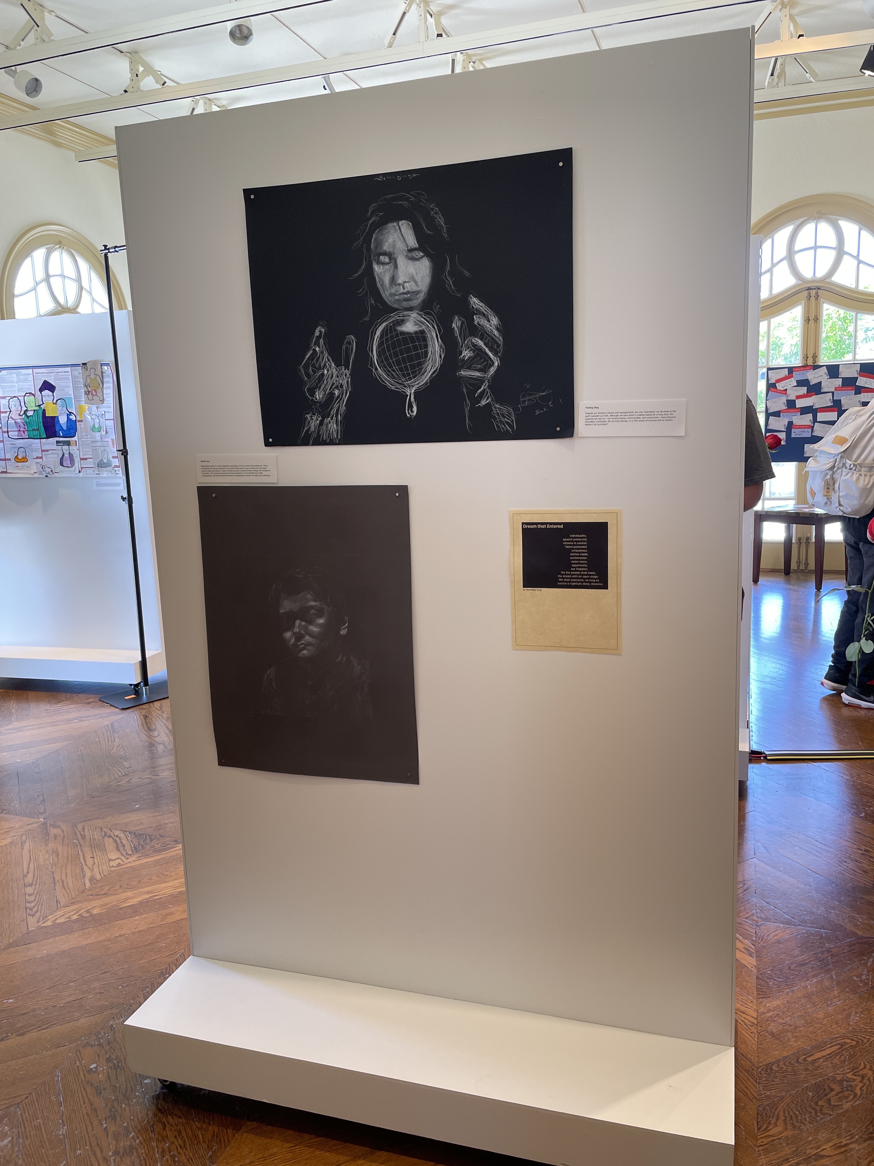 Part of the Expanding the Story of Belonging exhibit showing student art and poetry