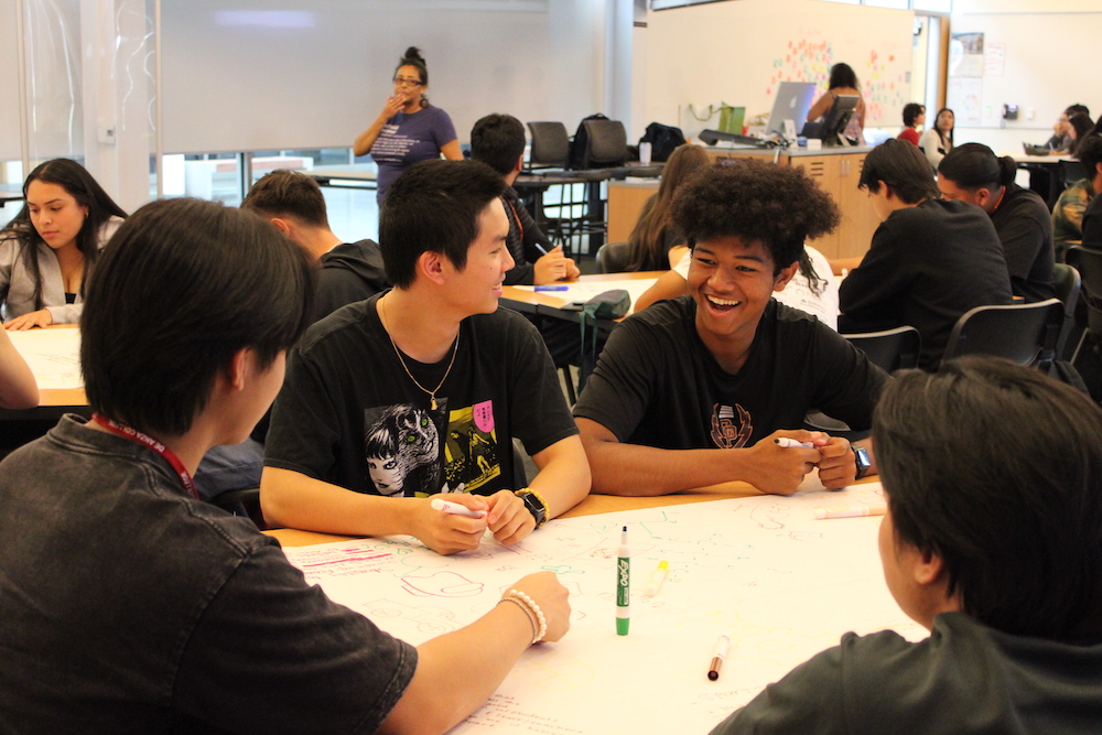 young men smiling at table