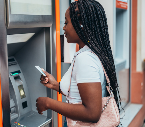 young woman at cash machine